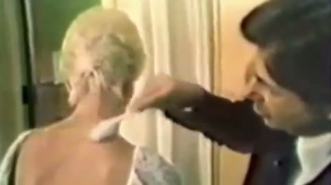 Dr. Jacob brushing DMSO into Sandy's back
                  and neck