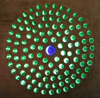 Bottle rosette in a
                    partition wall of an earthship in Spain