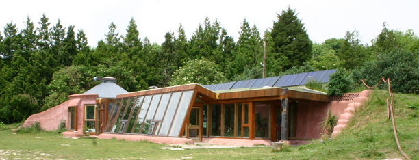 An earthship in Brighton with
                      solar system on it's top