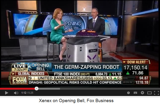 CEO Maurice Miller of XENEX company,
                            with reporter and UV light robot