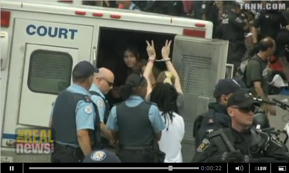 Die junge Frau Mystery muss in den
                            K�figwagen steigen, mit Friedenszeichen